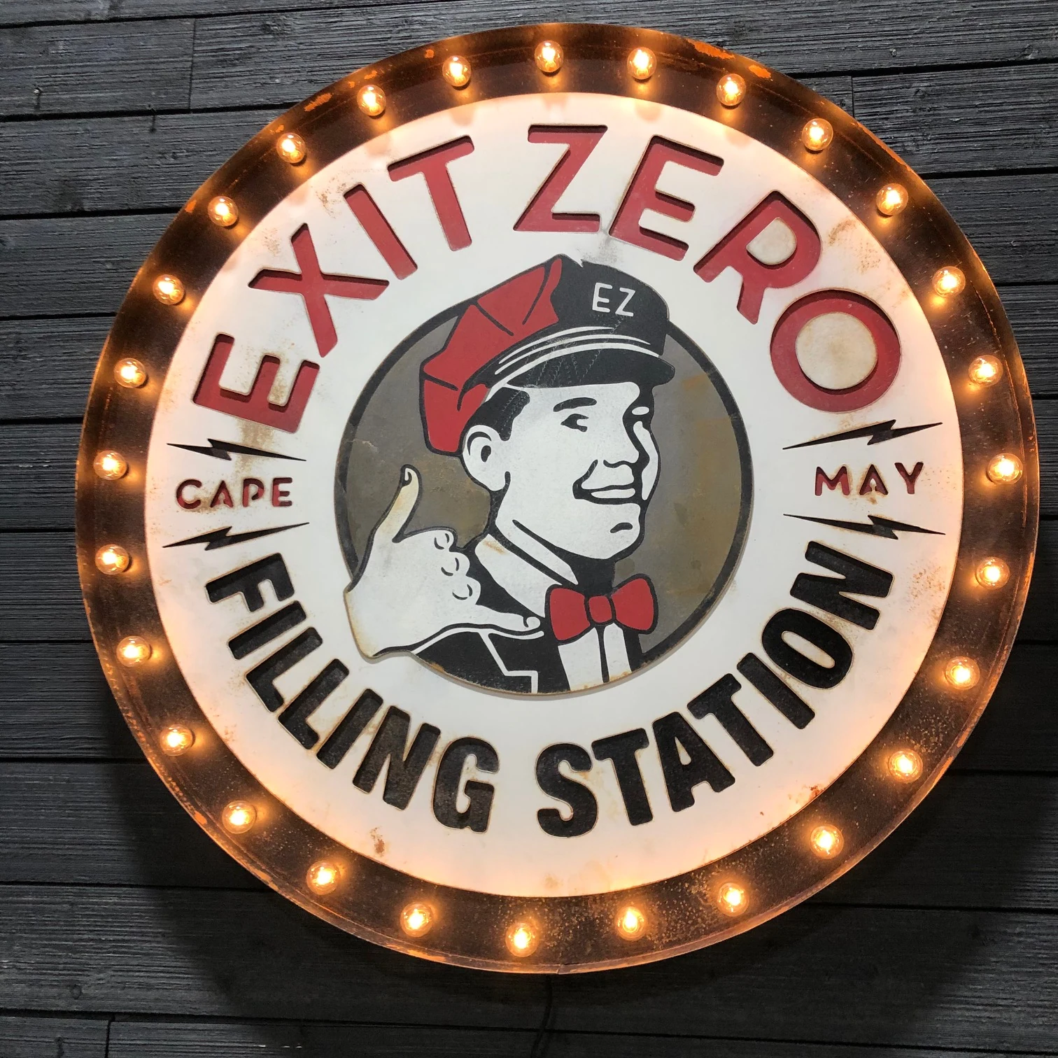 Finished illuminated Exit Zero sign on the fabrication shop wall
