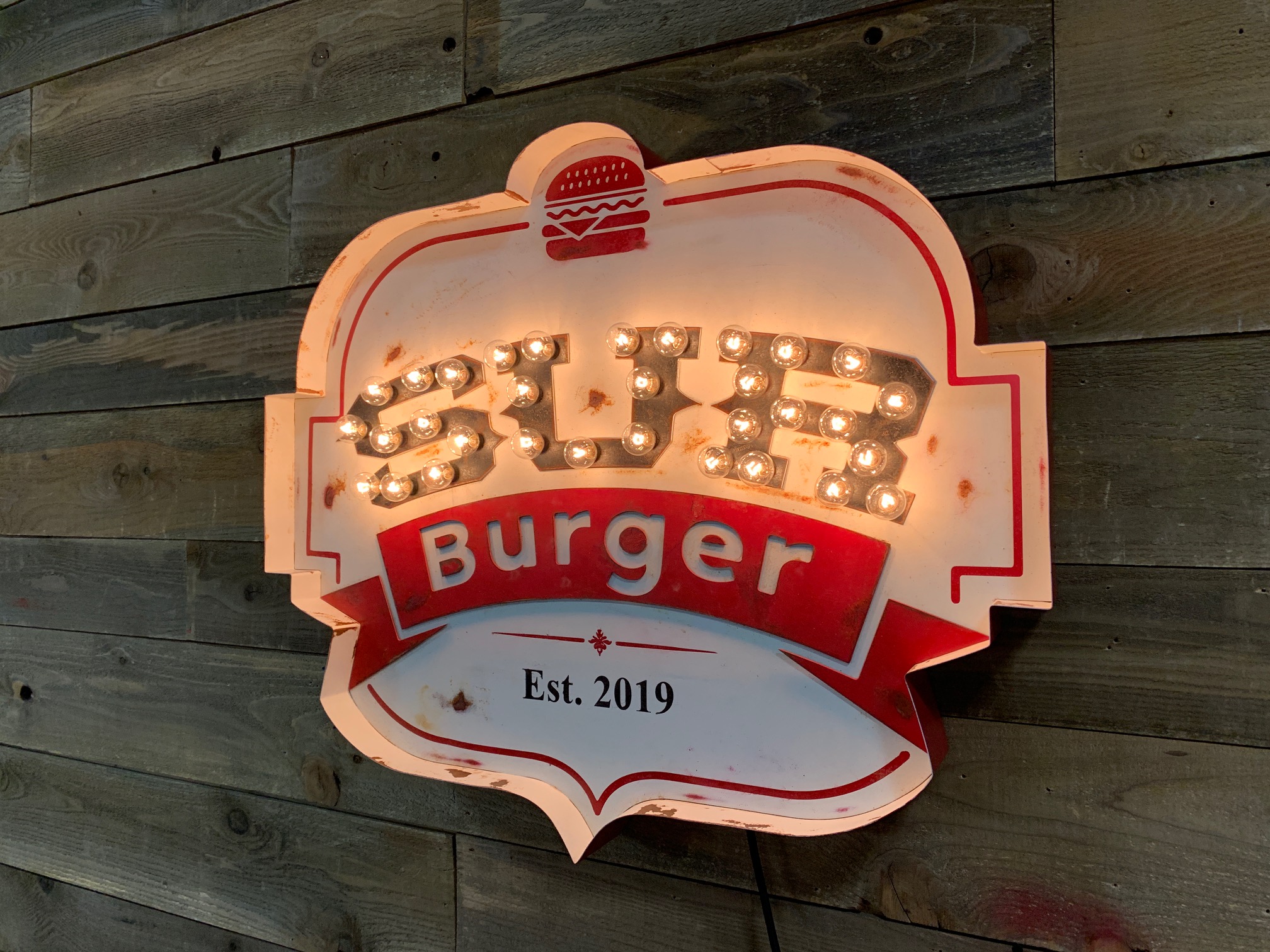 Sur Burger badge-shaped sign with bulb-lit border and vintage finish