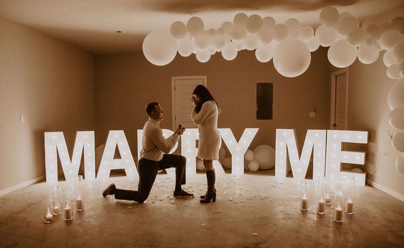 Stand-up marquee letters spelling MARRY ME at an indoor event display