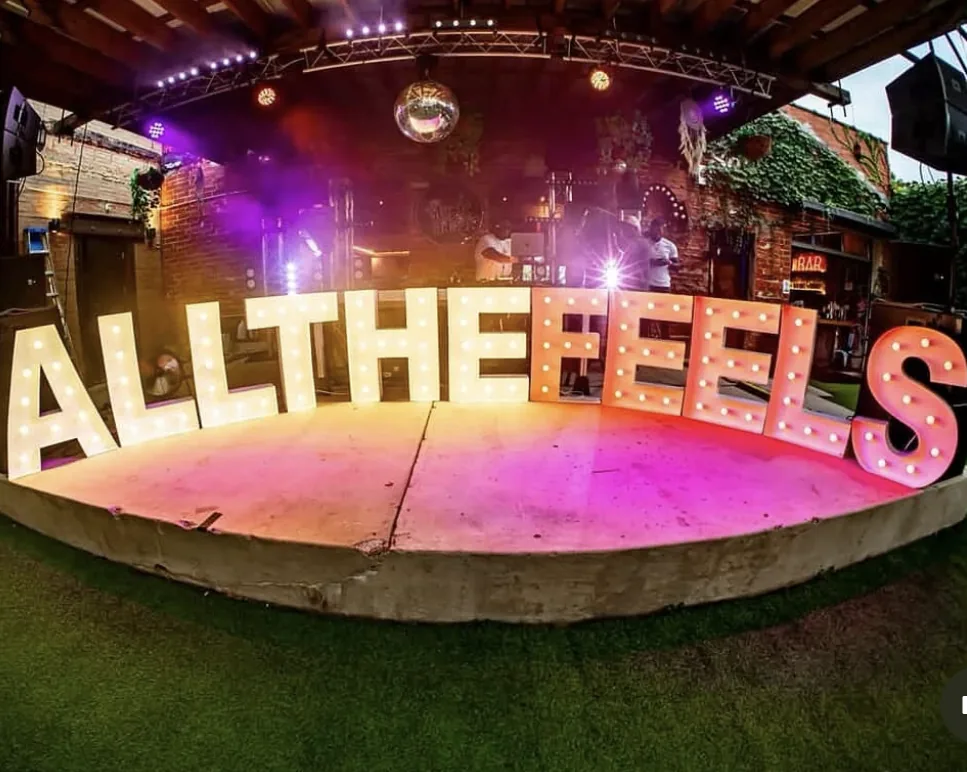 ALLTHEFEELS marquee lights at an outdoor C&D Marquees event setup